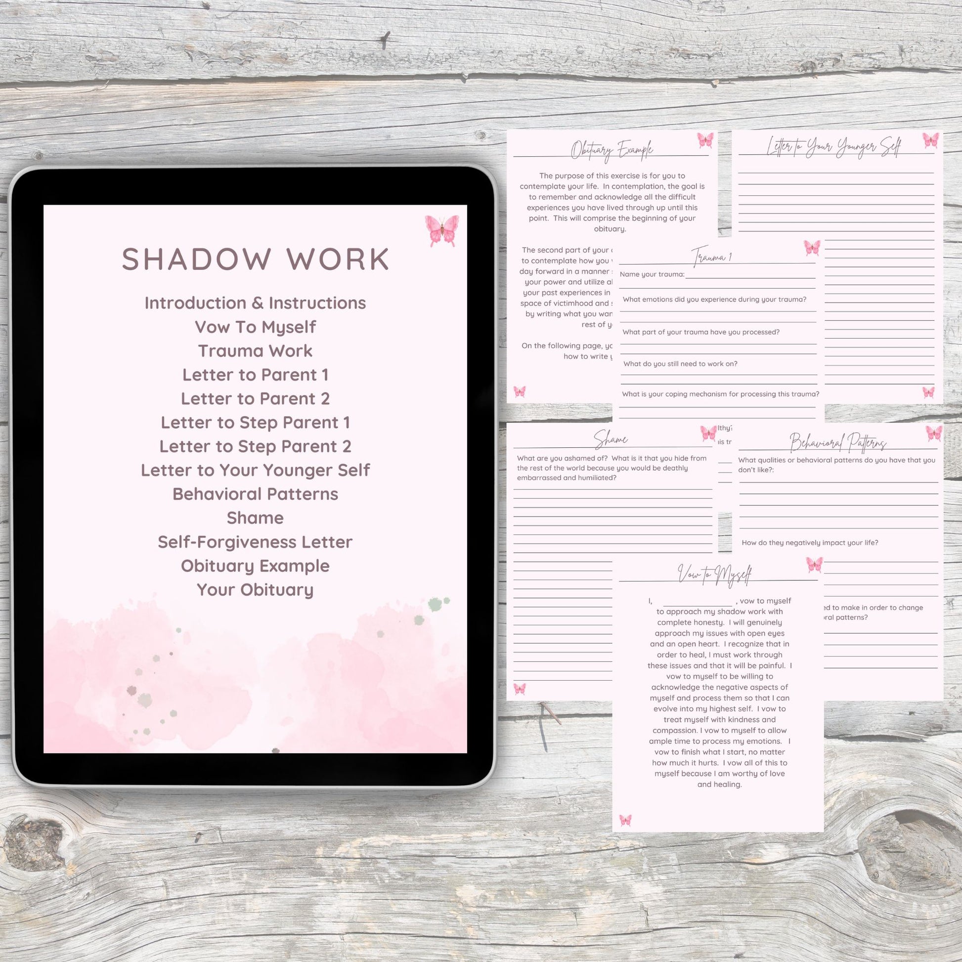 Black tablet laying on grey and white wooden desk.  Tablet displays main index page of the shadow work section of the digital planner.  Detailed pages lay on the desk right of the tablet.